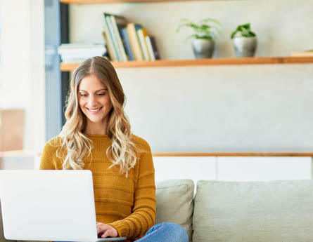 Woman on couch on laptop.