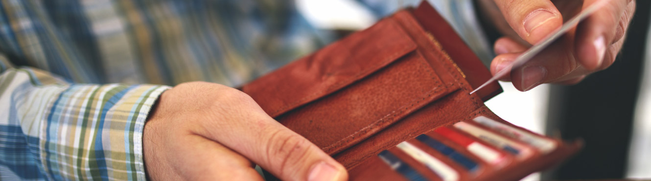 A man pulls out a card from his wallet