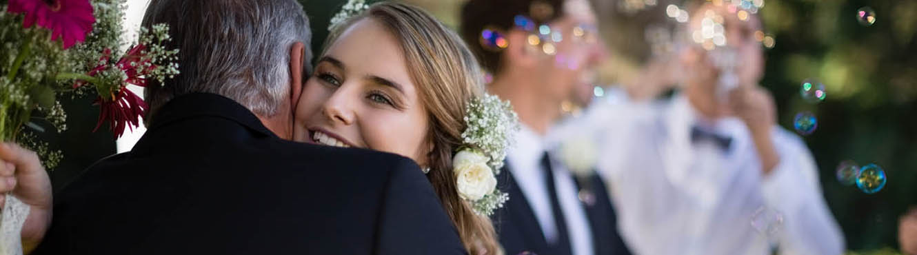 Bride hugging her dad at her wedding.