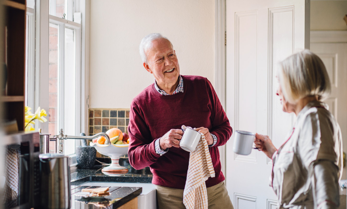 A mature couple joyfully converse over coffee