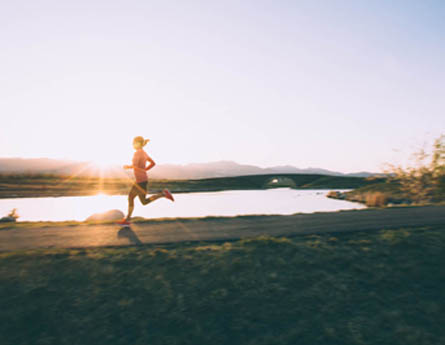 Woman running by lake.