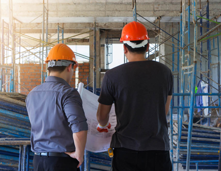 Construction workers looking at blueprints