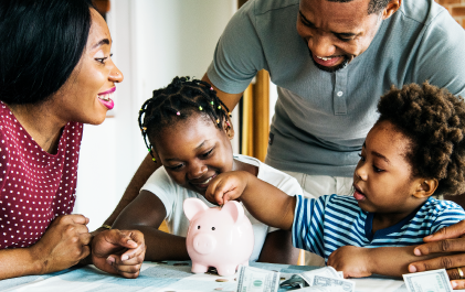 Family saving blog cover image - family gathered at a table putting money in a piggy bank