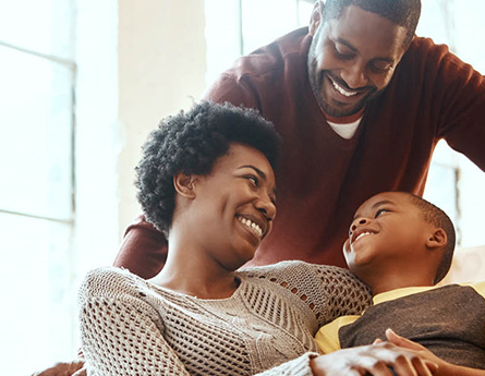 Happy mother and father with young son