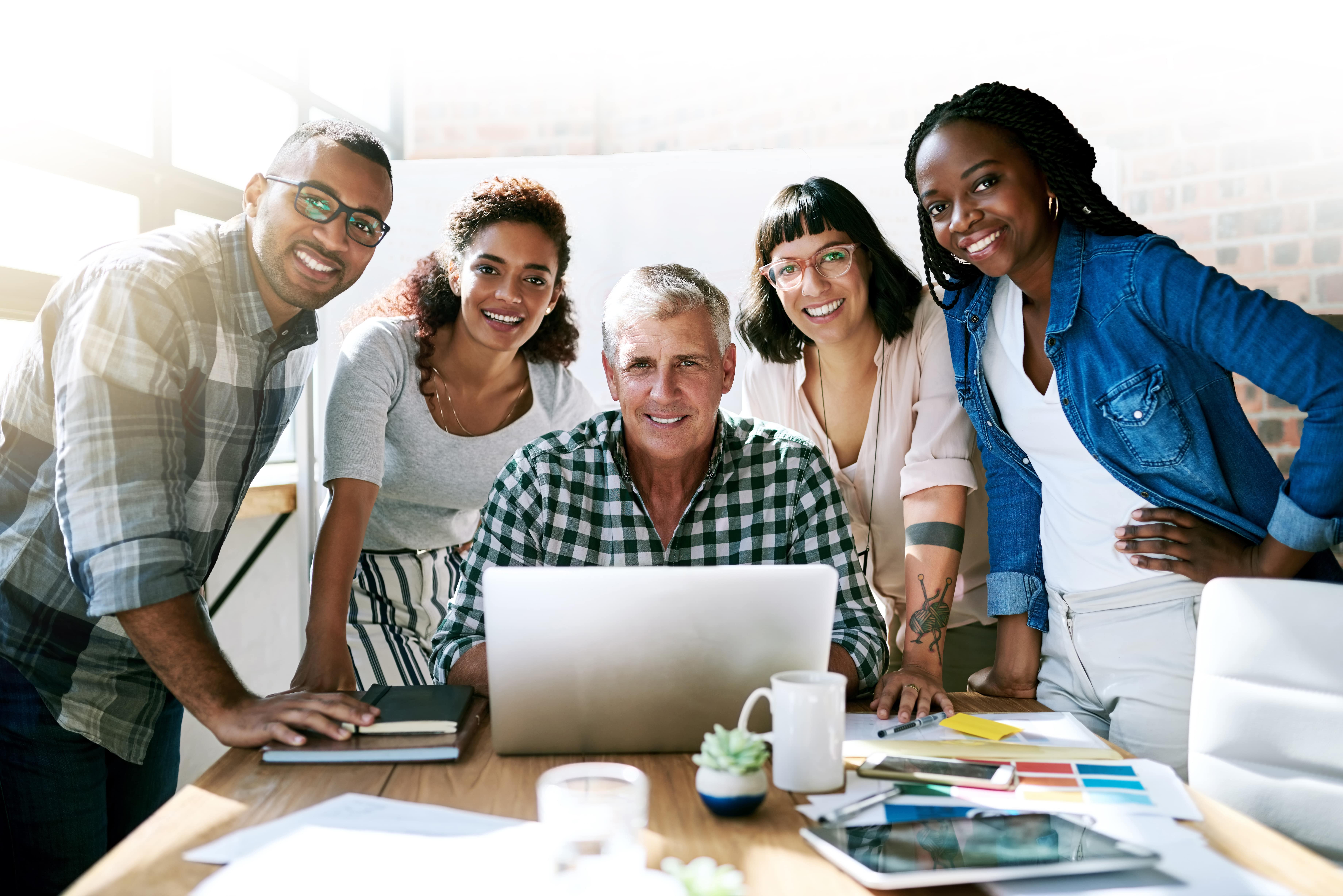 Group of people looking at a laptop