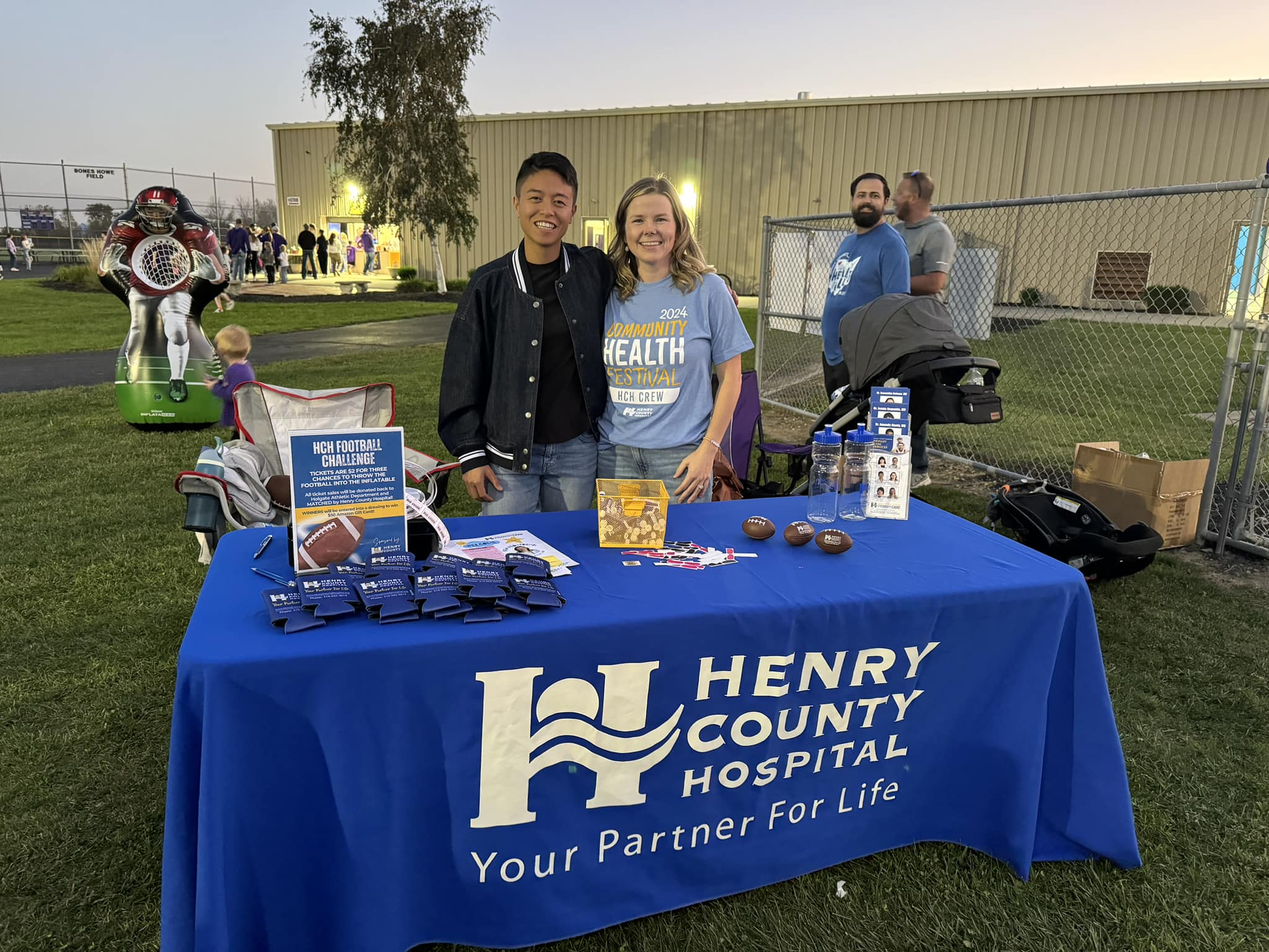 Dr. Manly & Dr. Bolman hosting a booth at a local high school homecoming event.