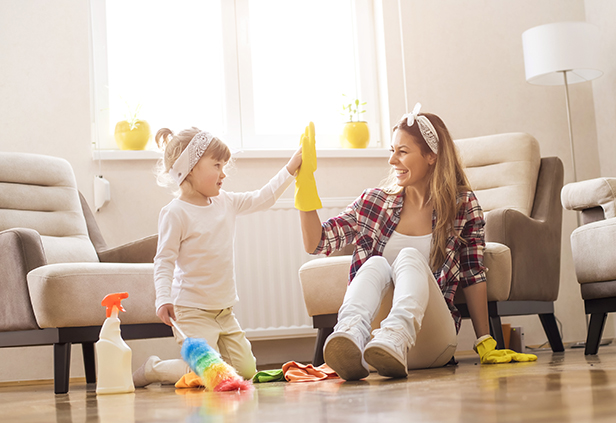 Mother and daughter cleaning their home