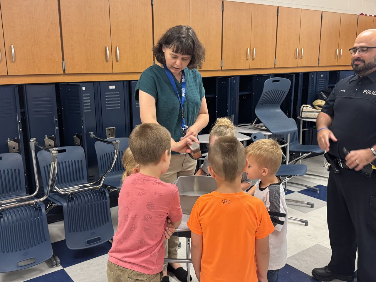 Dr. Reynolds showcasing proper hand hygiene techniques at a school presentation.