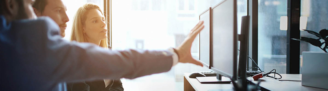 Business team discussing something displayed on their computer screens