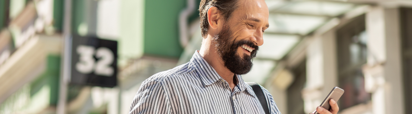 Man smiling looking at phone