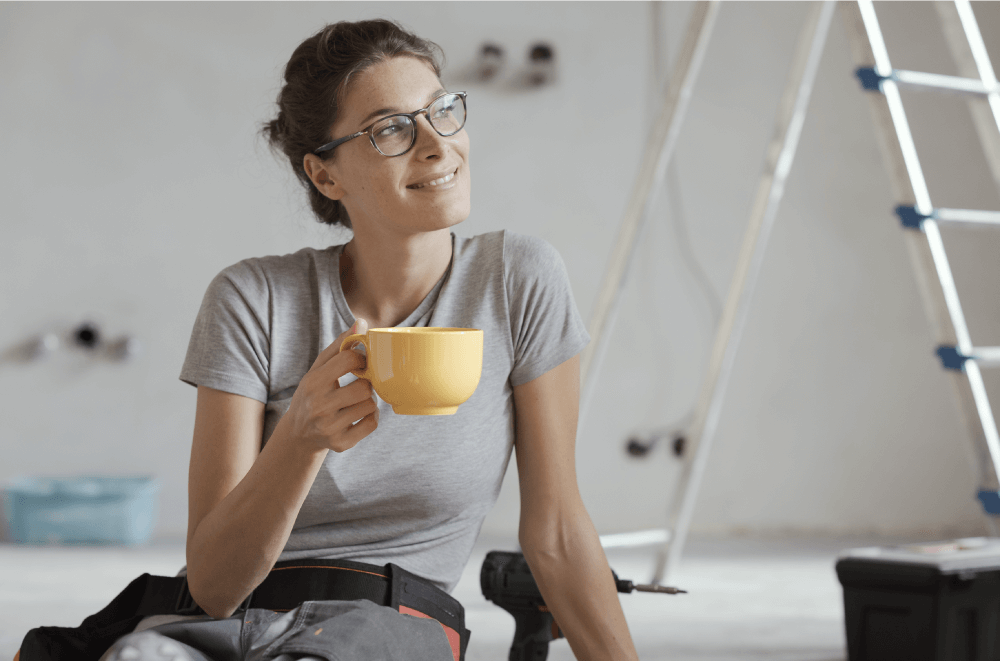 woman drinking coffee working on home improvement