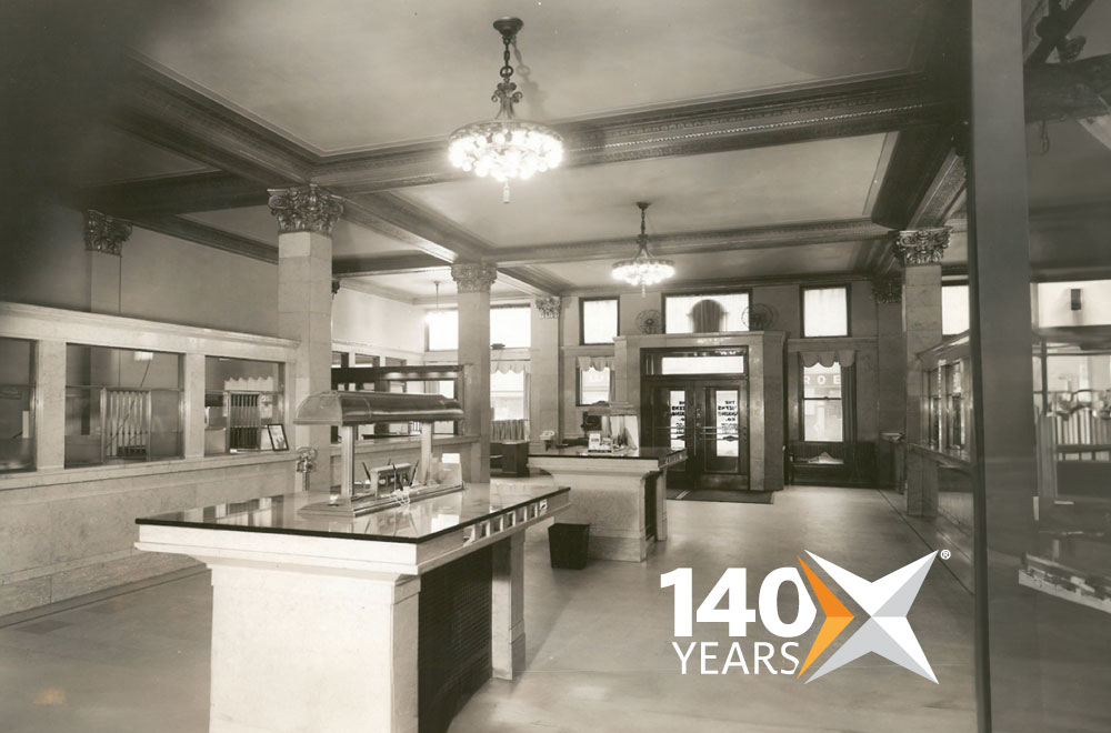 Black and white image of the inside Civista Bank lobby with 140-year anniversary graphic in corner.