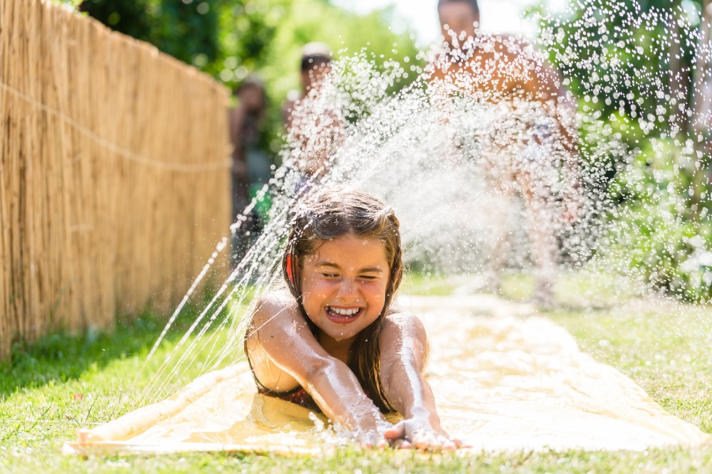 girl playing on slip-n-slide