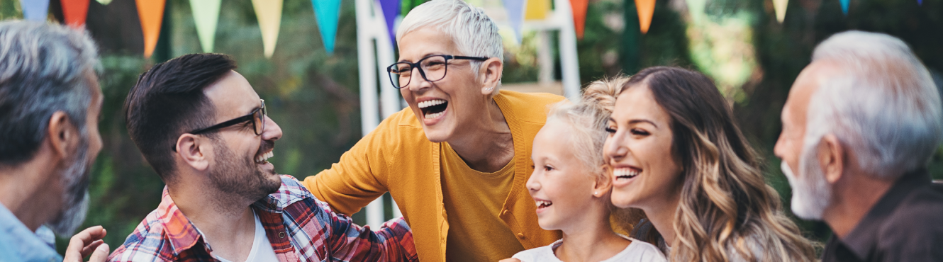 Multi generational family laughing at table