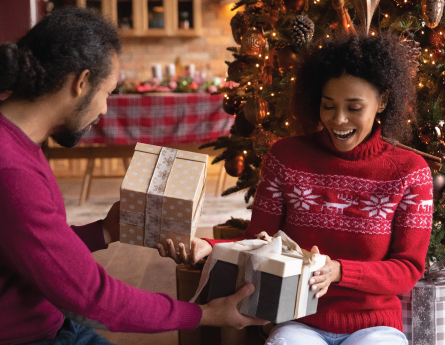 Couple exchanging gifts on Christmas morning.