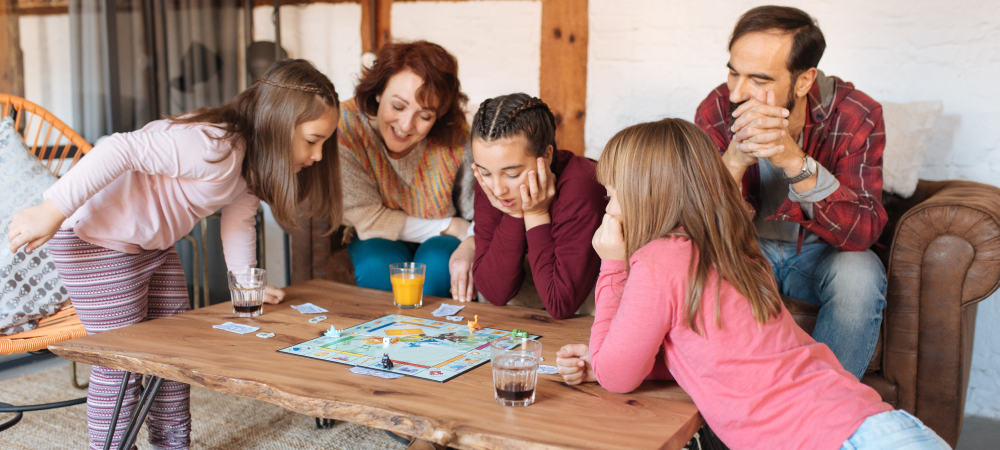 Family playing Monopoly for family game night