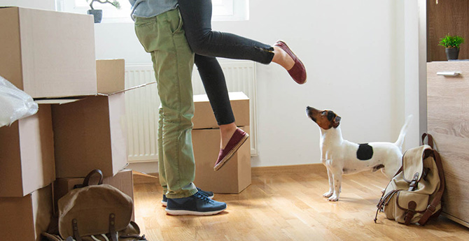 Couple celebrating new home with puppy.