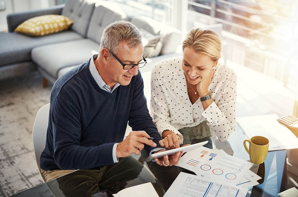 Couple reviewing and celebrating their financial wins so far.