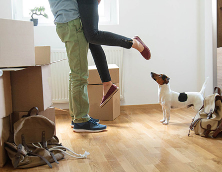 Couple celebrating new home with puppy.