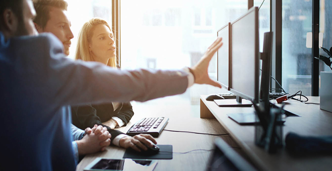 Business team looking at something displayed on computer