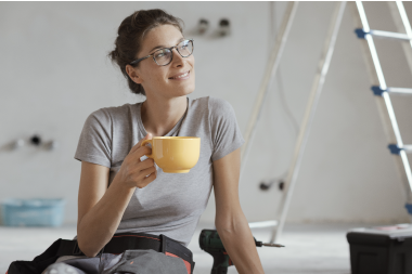 woman drinking coffee working on home improvement