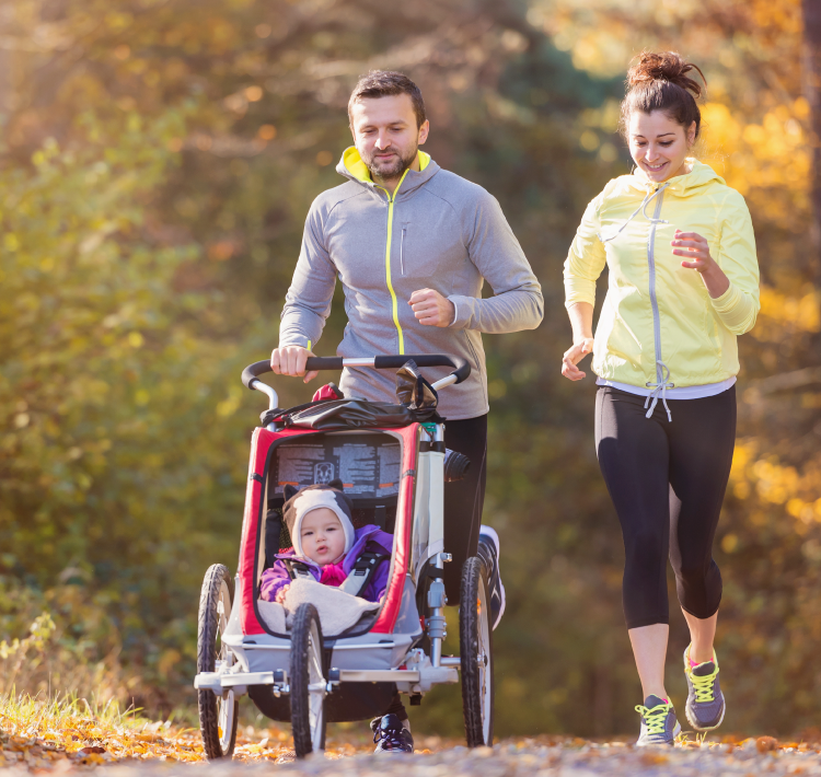 Young couple running with baby