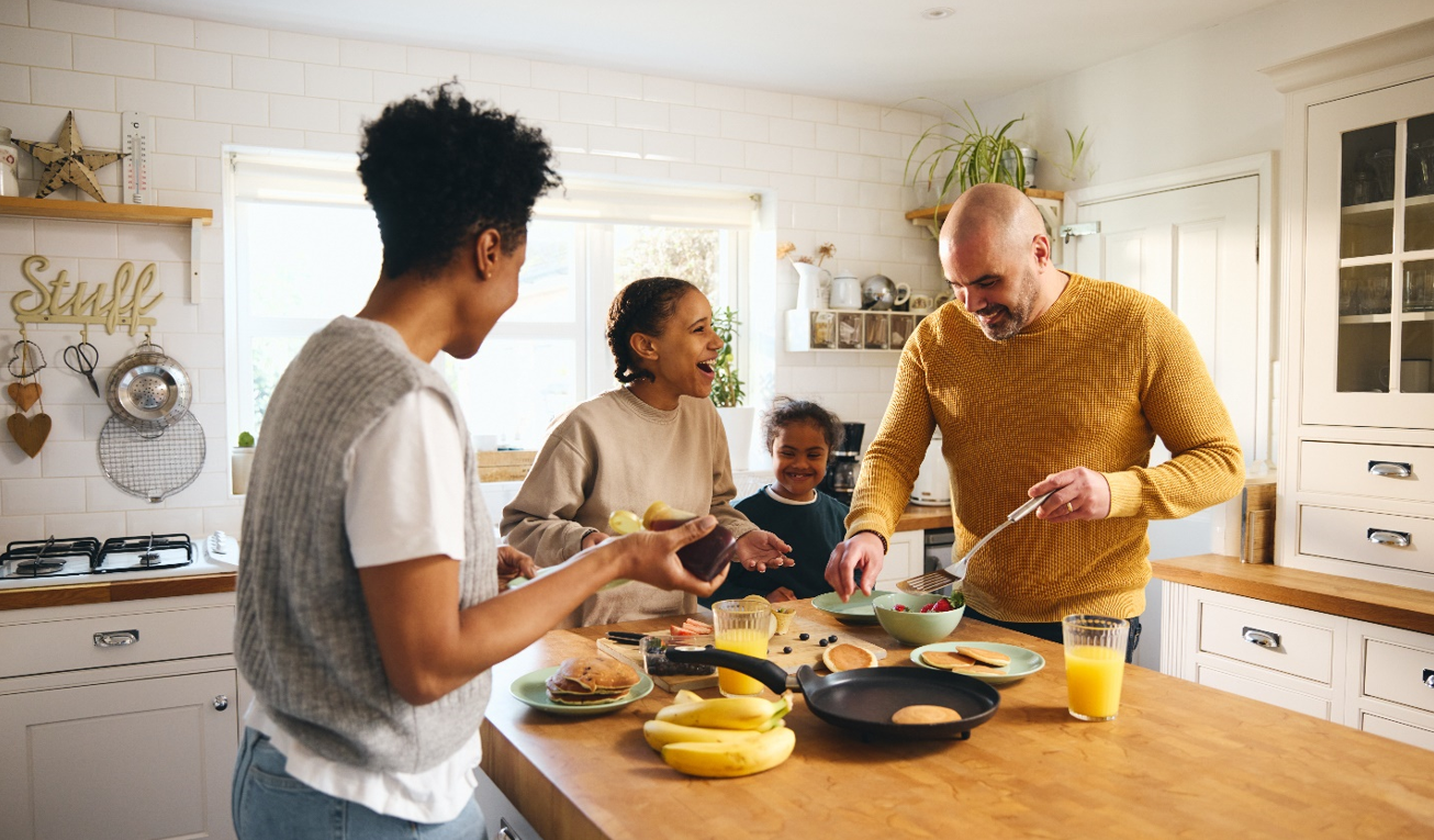 Family making and eating breakfast together