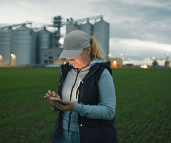 Farmer woman in field on phone