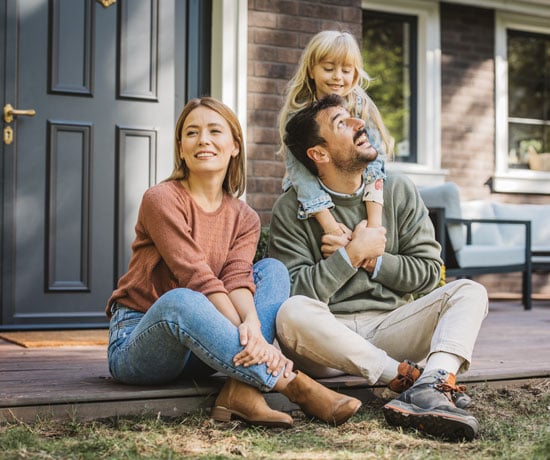 Family in front of their home