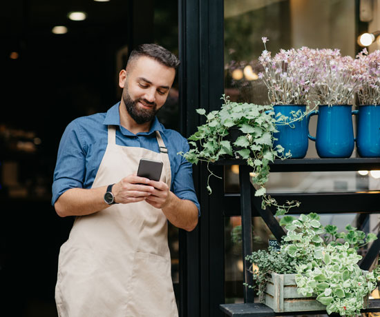 Business owner on cellphone and app
