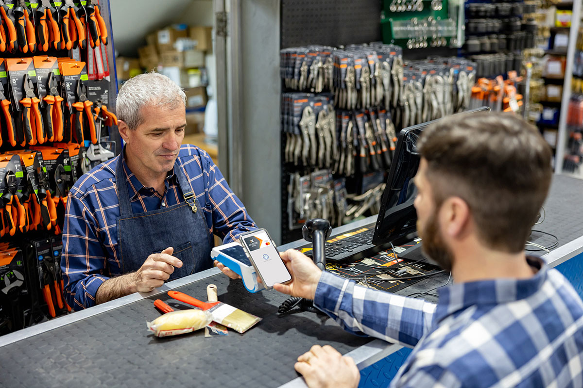 Man paying with digital wallet at a hardware store