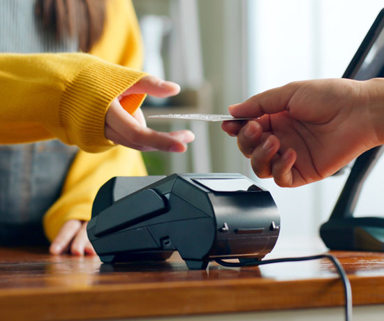 Person using debit card at check out point of sale
