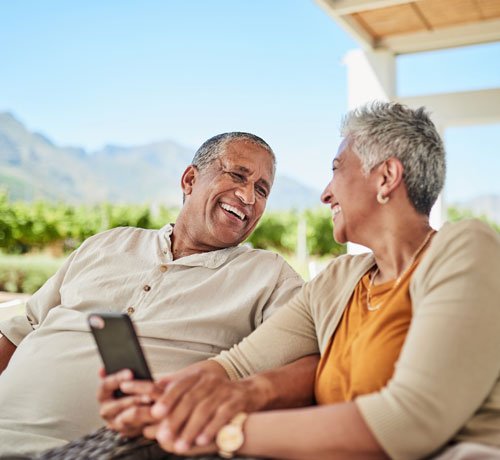 Happy couple outside on phone