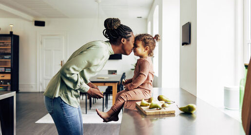 Loving-mom-and-her-little-girl-having-a-snack-at-home
