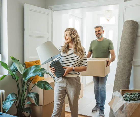 Mature couple moving into a new home