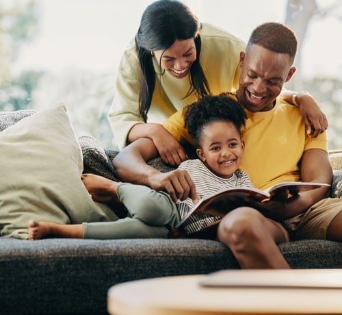 Happy black family on couch