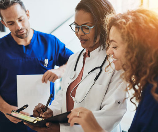 Diverse-medical-professionals-talking-together-in-a-hospital-